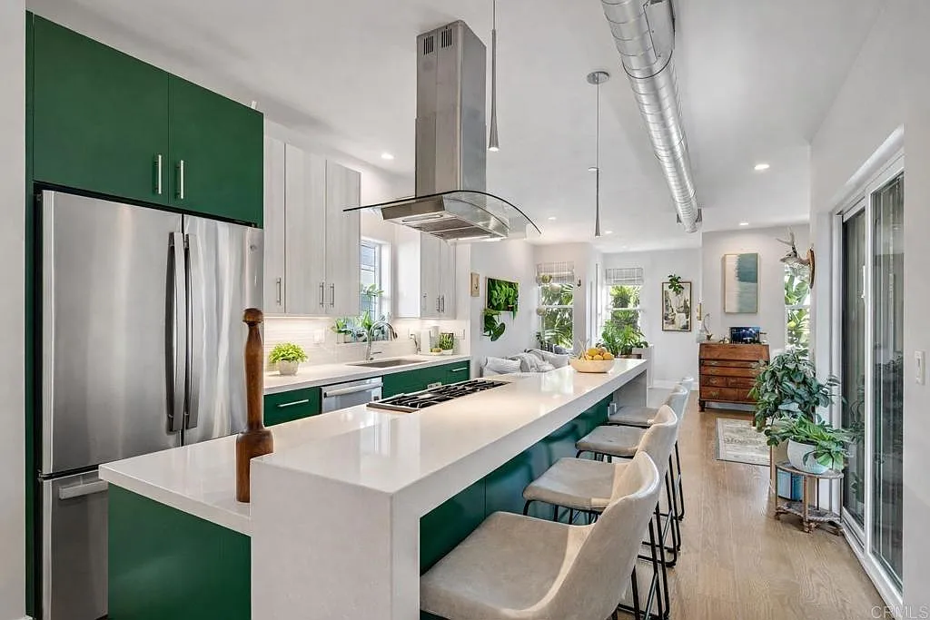 Kitchen with island and emerald cabinetry